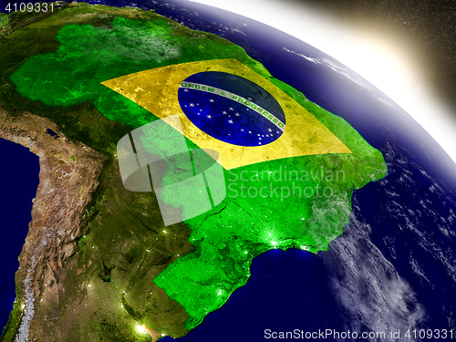 Image of Brazil with flag in rising sun