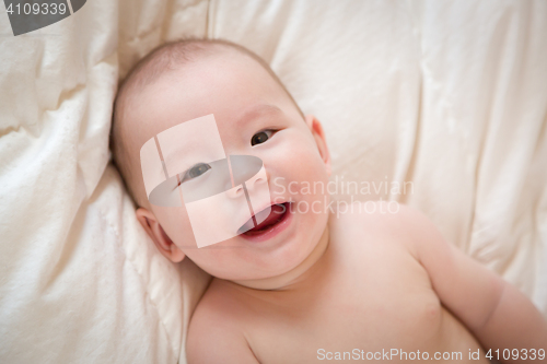 Image of Mixed Race Baby Boy Having Fun on His Blanket