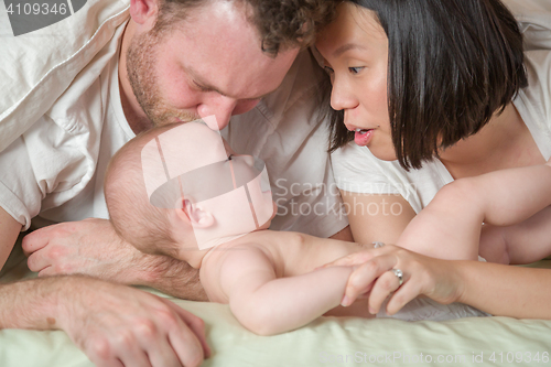 Image of Mixed Race Chinese and Caucasian Baby Boy Laying In Bed with His