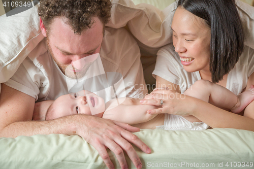 Image of Mixed Race Chinese and Caucasian Baby Boy Laying In Bed with His