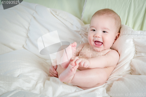 Image of Mixed Race Baby Boy Having Fun on His Blanket