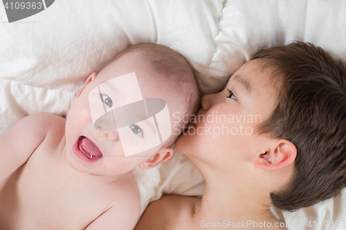 Image of Mixed Race Chinese and Caucasian Baby Brothers Having Fun Laying