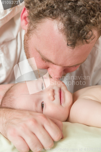 Image of Mixed Race Chinese and Caucasian Baby Boy In Bed with His Father