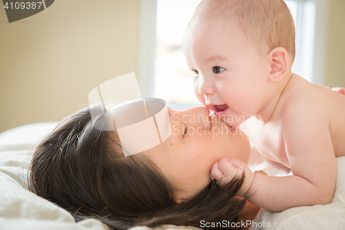 Image of Mixed Race Chinese and Caucasian Baby Boy Laying In Bed with His