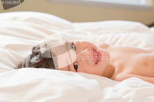 Image of Young Mixed Race Chinese and Caucasian Boy Laying on HIs Blanket