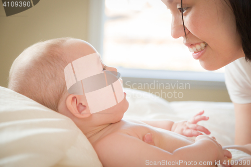 Image of Mixed Race Chinese and Caucasian Baby Boy Laying In Bed with His