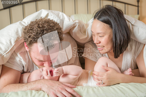 Image of Mixed Race Chinese and Caucasian Baby Boy Laying In Bed with His