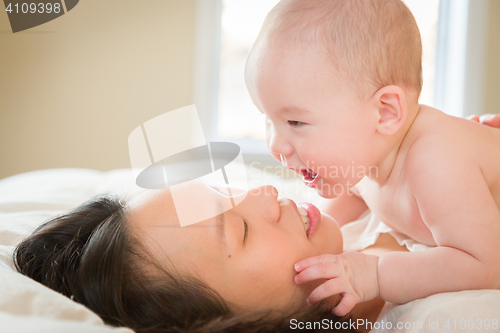 Image of Mixed Race Chinese and Caucasian Baby Boy Laying In Bed with His