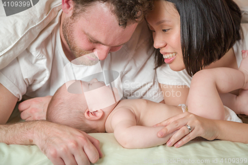 Image of Mixed Race Chinese and Caucasian Baby Boy Laying In Bed with His