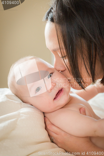 Image of Mixed Race Chinese and Caucasian Baby Boy Laying In Bed with His