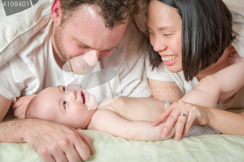 Image of Mixed Race Chinese and Caucasian Baby Boy Laying In Bed with His