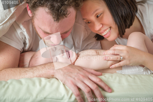 Image of Mixed Race Chinese and Caucasian Baby Boy Laying In Bed with His