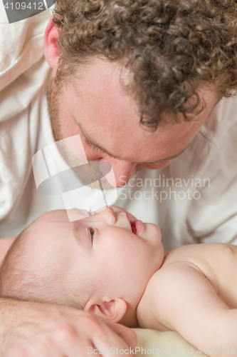 Image of Mixed Race Chinese and Caucasian Baby Boy In Bed with His Father