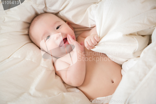 Image of Mixed Race Baby Boy Having Fun on His Blanket