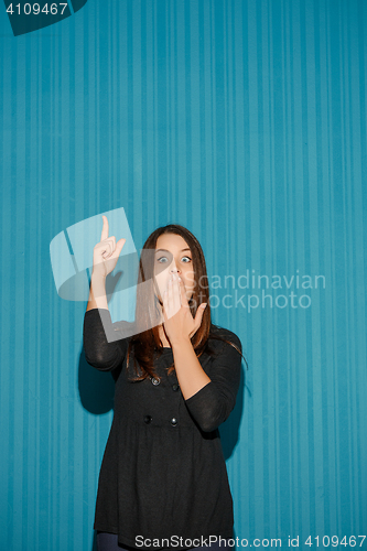 Image of Portrait of young woman with shocked facial expression