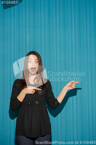 Image of Portrait of young woman with shocked facial expression