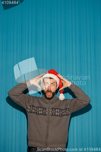 Image of The screaming christmas man wearing a santa hat