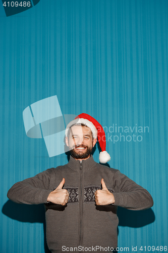 Image of Smiling christmas man wearing a santa hat