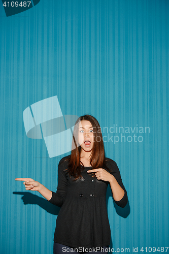 Image of Portrait of young woman with shocked facial expression