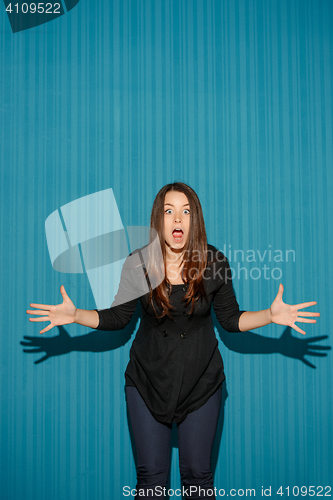 Image of Portrait of young woman with shocked facial expression