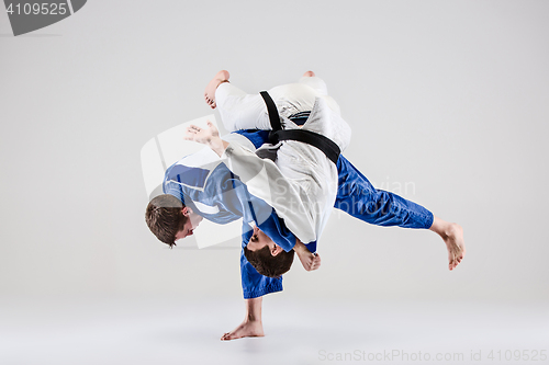 Image of The two judokas fighters fighting men