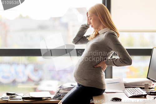 Image of pregnant businesswoman feeling sick at office work