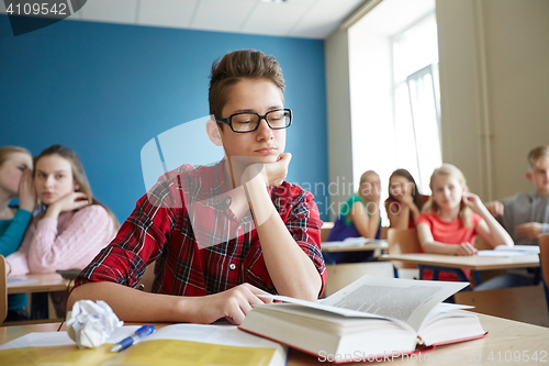 Image of students gossiping behind classmate back at school