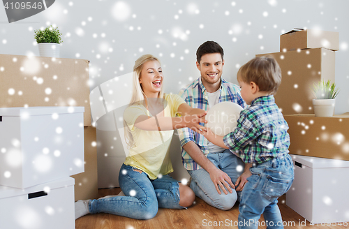 Image of happy family moving to new home and playing ball