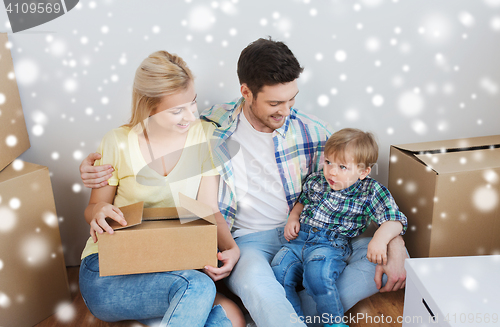 Image of happy family with boxes moving to new home