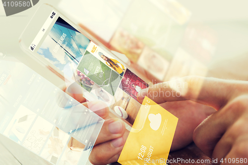 Image of close up of male hand with news on smartphone