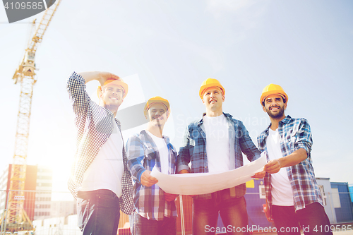 Image of group of builders with tablet pc and blueprint