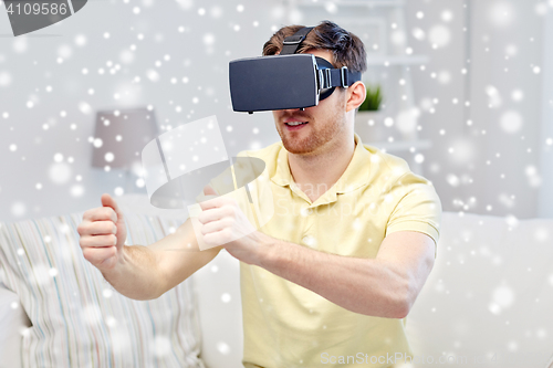 Image of young man in virtual reality headset at home