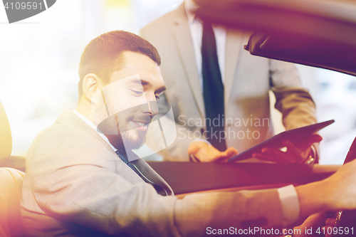 Image of happy man with car dealer in auto show or salon