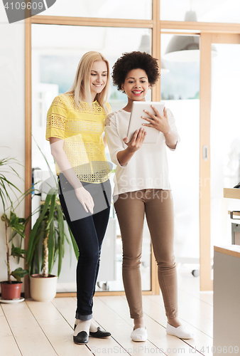 Image of happy creative team with tablet pc in office