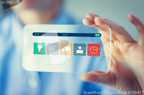 Image of close up of woman with transparent smartphone