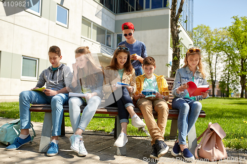 Image of group of students with notebooks at school yard