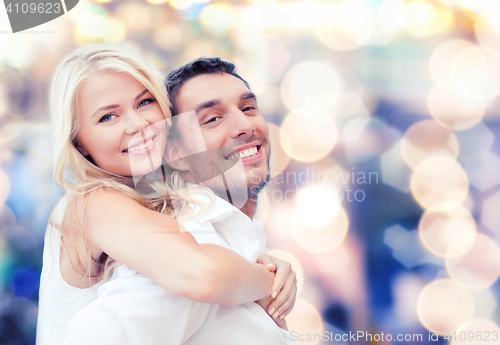 Image of happy couple having fun over lights background