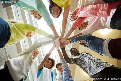 Image of group of international students with hands on top