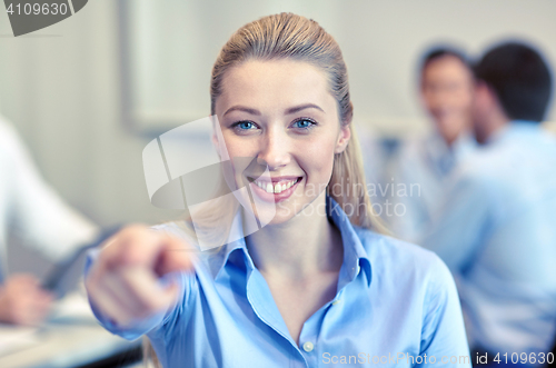 Image of smiling businesswoman pointing finger on you