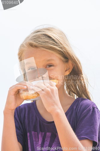 Image of A hungry girl with an appetite for biting a delicious pie