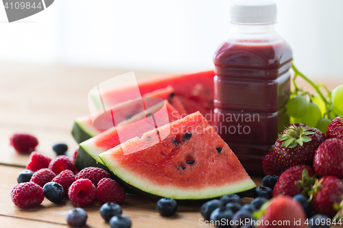 Image of bottle with fruit and berry juice or smoothie