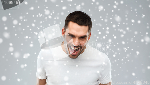 Image of angry man shouting over snow background