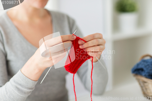 Image of woman hands knitting with needles and yarn