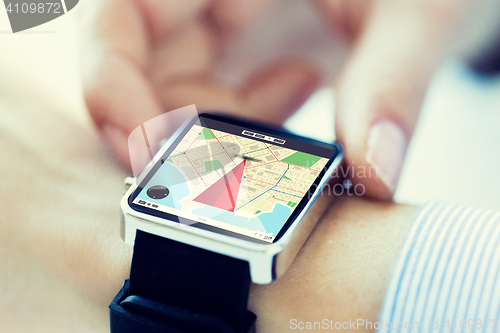 Image of close up of hands with map on smartwatch screen