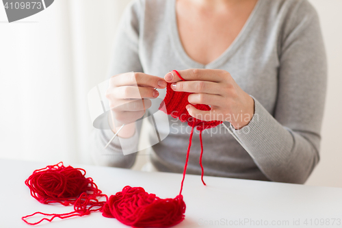 Image of woman hands knitting with needles and yarn