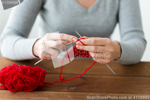 Image of woman hands knitting with needles and yarn