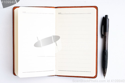 Image of notepad with pen isolated