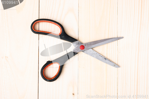 Image of Scissors on wooden background