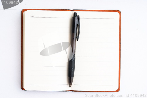 Image of notepad with pen isolated