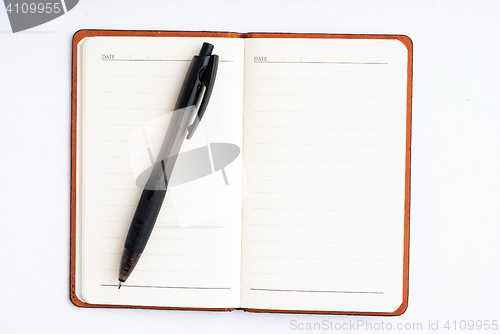 Image of notepad with pen isolated